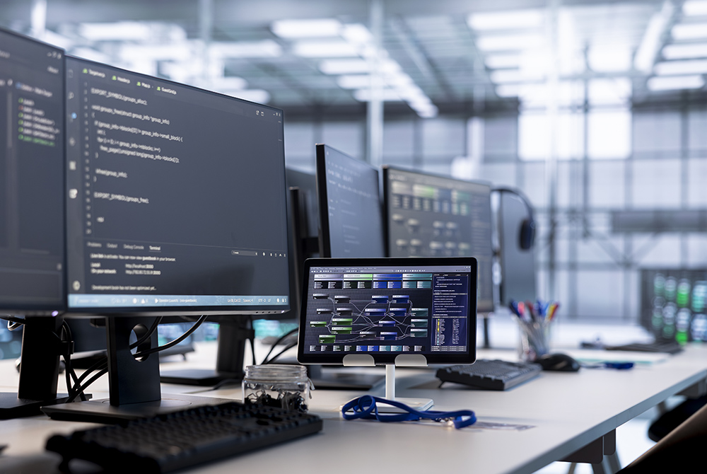 Close up of PC screen and tablet on desk used for monitoring data center devices